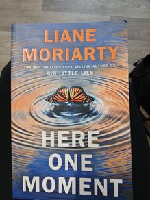 here one moment by liane moriarty author of big little lies. bestsellering fiction.