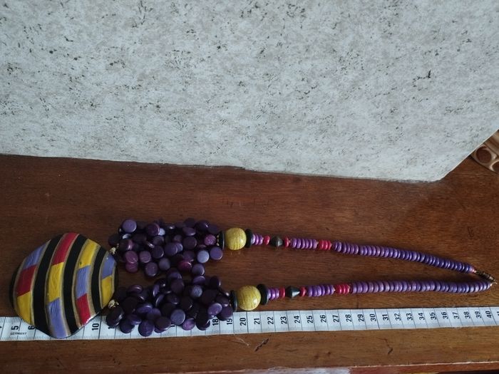 Vintage spectacular necklace made of wooden beads and medallion.