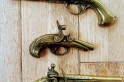 Three vintage brass pistols