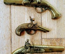 Three vintage brass pistols