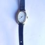 Vintage Timex womens quartz watch - gold tone oval case, white dial and black strap Image 2