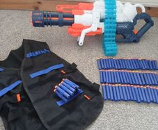 Nerf Gun extra large with bullets and gun vest to hold bullets.