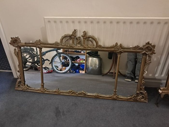 Two distinct antique giltwood mirrors with elaborate French-style ornamentation