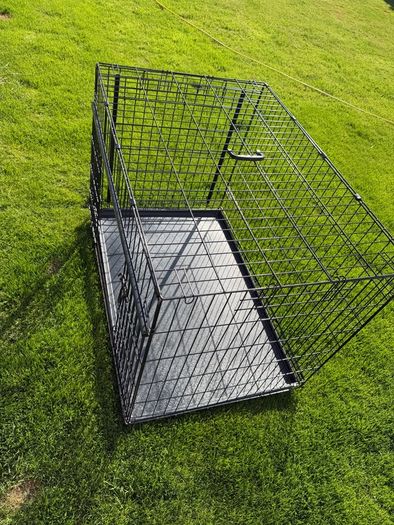 XL dog crate opens up by sliding doors at front and side. Read caption