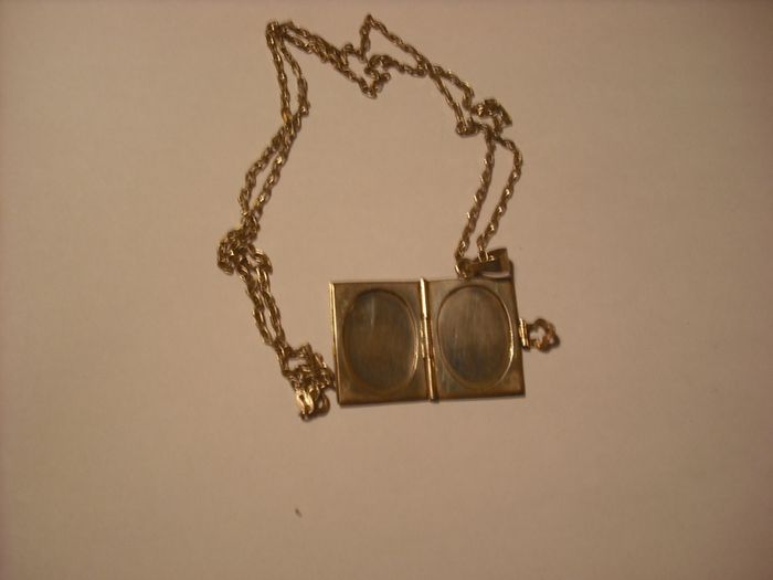 a lovely solid  silver locket and silver chain. in the shape of a book