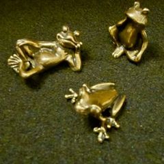 3 brass frogs.