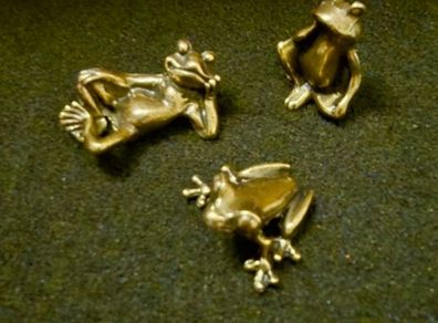 3 brass frogs.