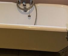 Claw legged roll top cast iron bath