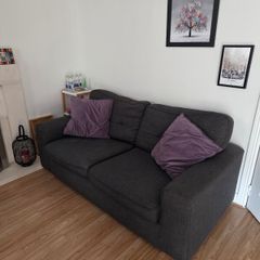 Charcoal Grey Sofa and two purple cushions