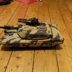 toy tank and army of toy soldiers
