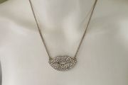 Gold tone sparkling lips necklace
