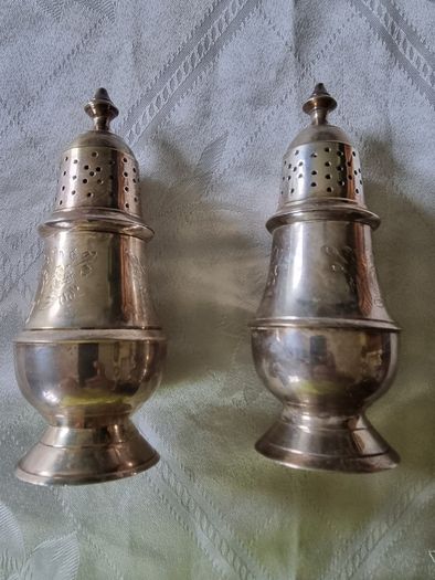 A pair of silver-plated salt shakers