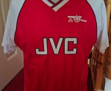 Arsenal official score draw retro shirt.
