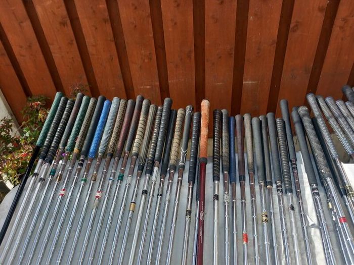 A selection of Golf clubs. Bags and golf balls.