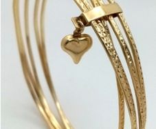 A 14K Yellow Gold Bangle Cluster Bracelet.