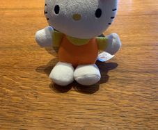 Hello Kitty plush toy in orange and yellow