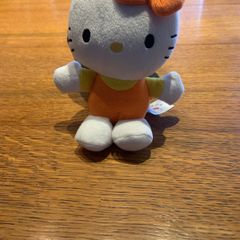 Hello Kitty plush toy in orange and yellow