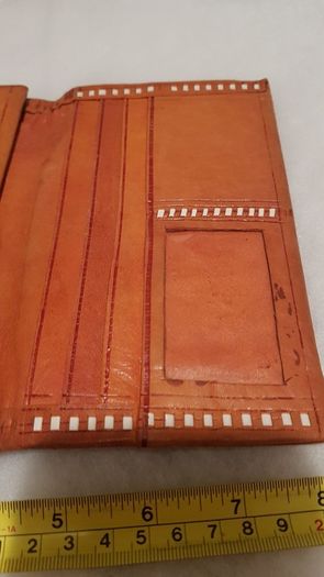 handcrafted made soft leather wallet,with designs ,, thank you,,was used,some wear and tear,,take as is ..