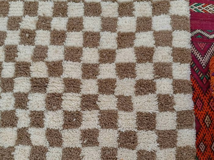Handwoven beige checkerboard rug
