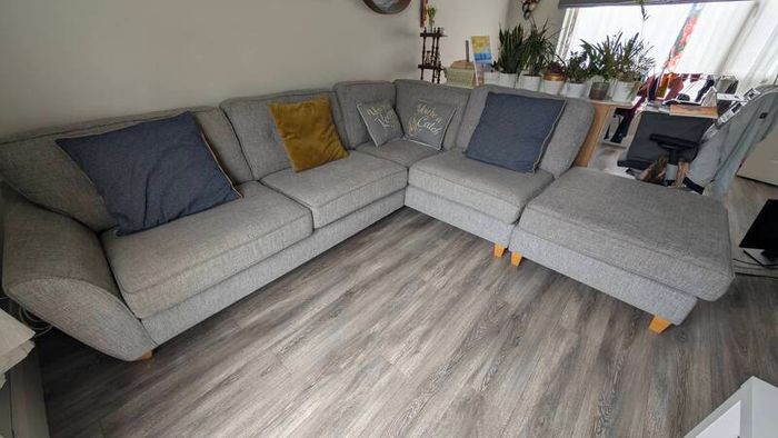 Gray fabric corner chase sofa with footstool