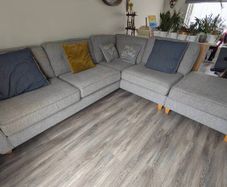 Gray fabric corner chase sofa with footstool