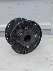 Empty black plastic reel