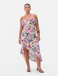 New floral ruffle dress features a vibrant asymmetrical design with delicate tie straps