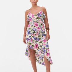 New floral ruffle dress features a vibrant asymmetrical design with delicate tie straps