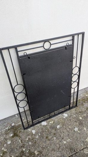 Mirror in a black metal frame