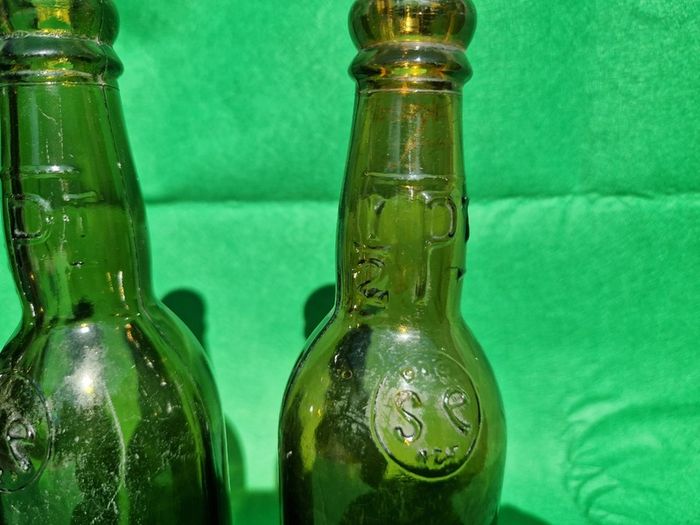 24 Antique 1/2 pint bottles in crate
