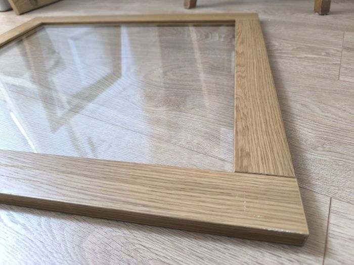Original IKEA BESTA cabinet door/front panel in discontinued natural oak finish with clear glass centre.