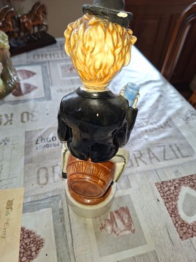 1950s to 70s Working Musical Decanter Hobo Clown Sitting on a Barrel. The base plays the tune Show Me the Way to Go Home, reminded me of the song from Jaws
