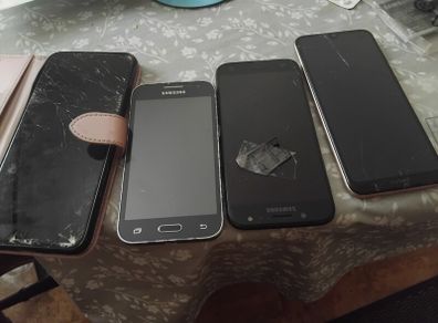 Selection of mobile phones.  Needs repairs