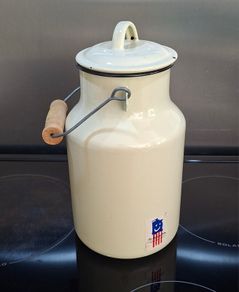 Vintage cream-coloured enamelware milk churn