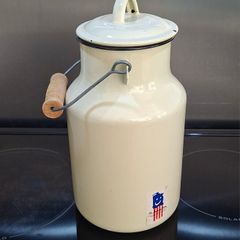 Vintage cream-coloured enamelware milk churn
