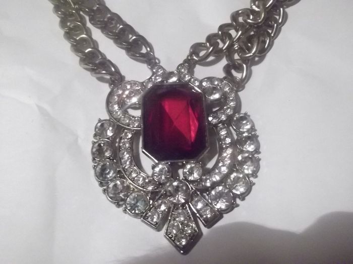 a lovely vintage  costome jewelley pendent with white stones and a large red stone