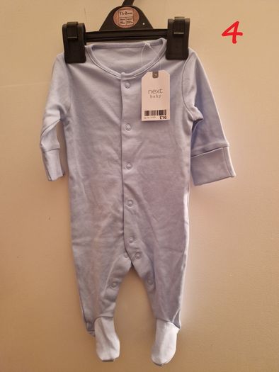 A selection of brand new baby clothes and items