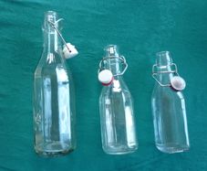 Bottles with swing top lids
