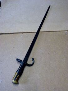 19th century French bayonet with brass and wooden handle.