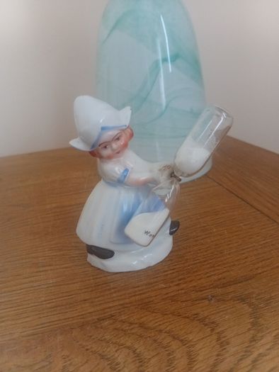 vintage porcelain egg timer featuring a dutch girl in traditional dress