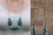 Turquoise and grey teething necklace for babies and parents.