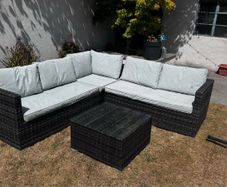 Rattan garden sofa set with glass top table