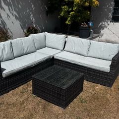 Rattan garden sofa set with glass top table
