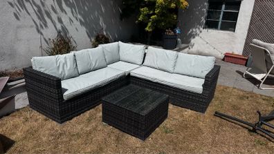 Rattan garden sofa set with glass top table