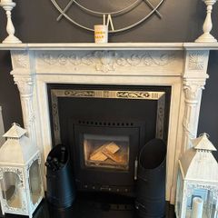 Ornate white marble fireplace surround