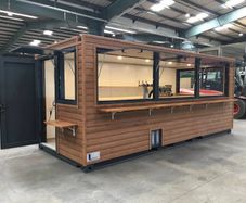 A 6-meter (20-foot) shipping container housing a cafe, with a very minimalist design