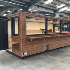 A 6-meter (20-foot) shipping container housing a cafe, with a very minimalist design