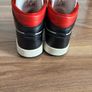 Nike Air Jordan 1 Mid trainers in the classic black, white and red colourway Image 8