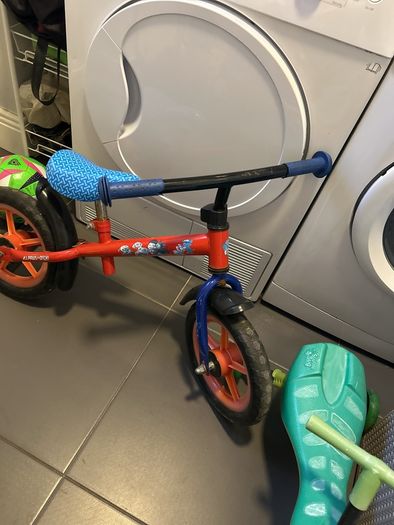 Two toddler bikes and a balance bike