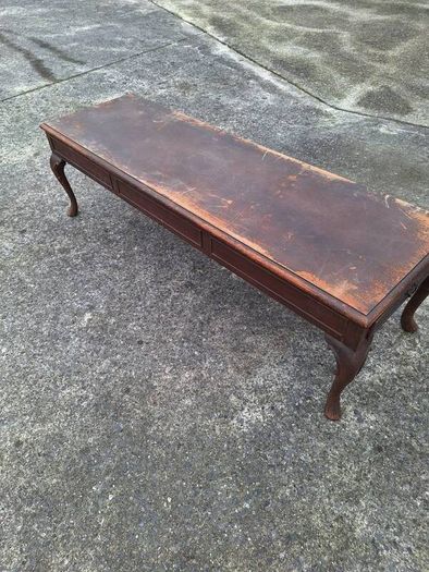 Antique wooden coffee table in need of restoration